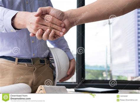 Engineer Handshaking For Successful Deal In Construction Plan A Stock