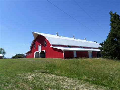 The clapboard siding and cedar stained doors the great western style of barn packages. Beautiful Red horse barn | For The Future (Hopefully) | House styles, Barn, House