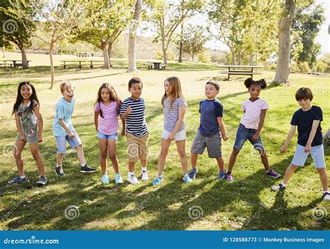 Multi Ethnic Group Of Schoolchildren Playing In Park Stock Image