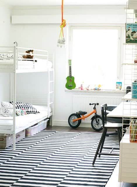 A Room With Two Bunk Beds And A Bike In It