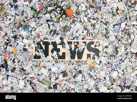 Newspaper Confetti From Above With The Word News Background Stock Photo