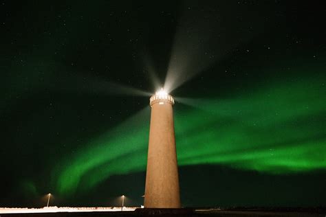 Lighthouse Against Majestic Green Polar Lights · Free Stock Photo