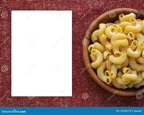 Rigati Pasta In A Wooden Bowl On A Red Brown Cloth Burlap Background