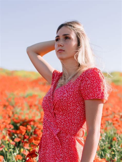 portrait of attractive woman in red dress on a poppy field stock image image of countryside