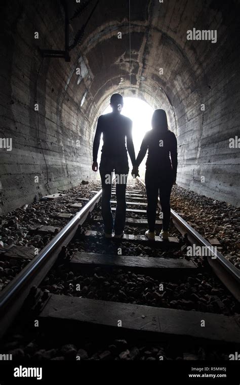 Couple Walking Together Through A Railway Tunnel Stock Photo Alamy