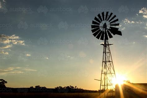 Image Of Windmill On A Farm At Sunset Austockphoto