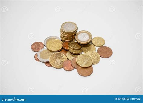 Pile Of Euro And Cents Coins Of Various Denominations On A White Desk