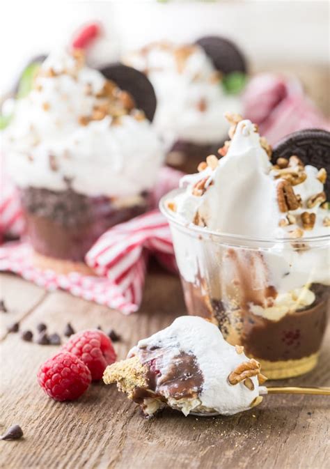 Chocolate chip cookie layered pudding dessert has layers of chocolate chip cookie dough, cream cheese, chocolate pudding, and cool whip. Individual 7 Layer Dessert Dip Cups - The Cookie Rookie®