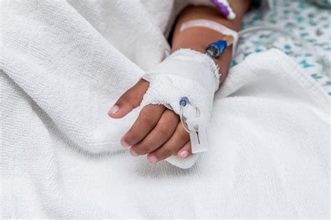 Childs Patient Hand With Saline Intravenous Drip Stock Photo Download
