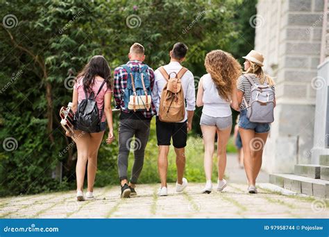 Group Of Attractive Teenage Students Walking From University Stock