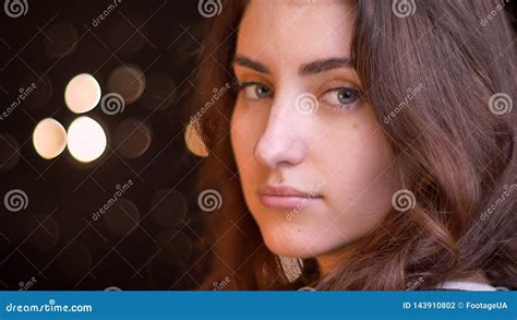 Closeup Side View Shoot Of Young Attractive Caucasian Female Face Turning And Looking At Camera