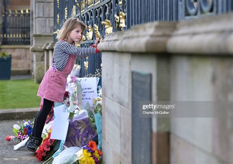 7 Year Old Betty Mcilwaine Peers Through The Gates As Members Of The