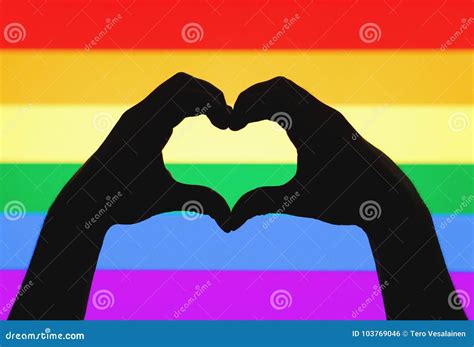 Hands Showing Heart Sign On Gay Pride And Lgbt Rainbow Flag Stock Photo