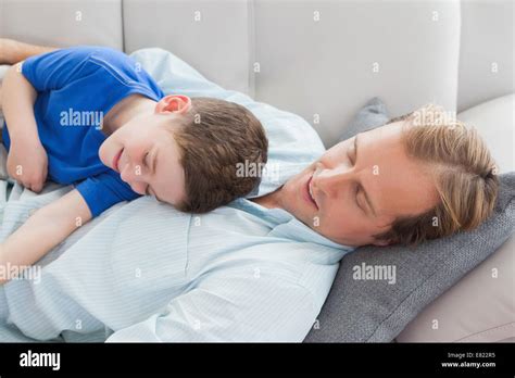 Father And Son Using Napping On The Couch Stock Photo Alamy