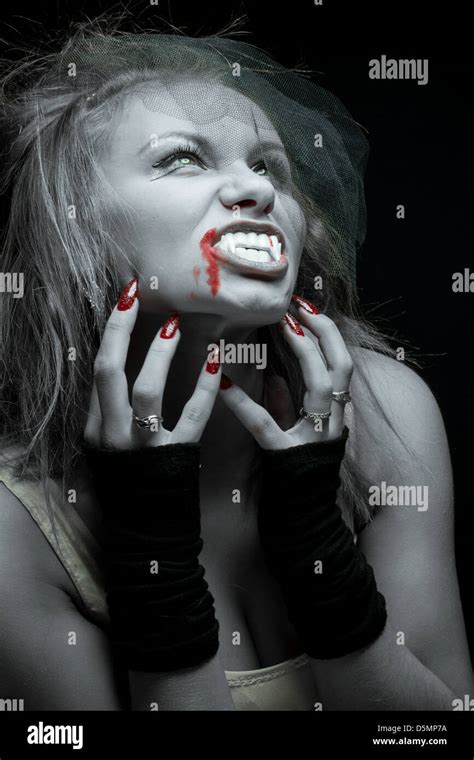 Woman Vampire With Fangs On A Black Background Stock Photo Alamy