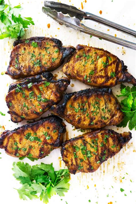Marinating pork chops is key to flavor and juicy texture. Super Easy Marinated Grilled Pork Chops • So Damn Delish