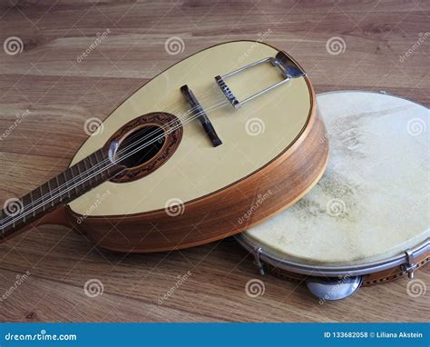 Close Up Of Two Musical Instruments Portuguese Mandolin And Pandeiro