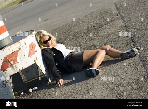 Drug Addicted Women Lying On The Asphalt Stock Photo Royalty Free Image Alamy