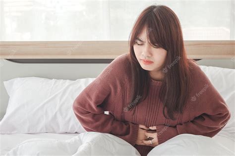 Premium Photo Asian Women Have Stomach Aches And Discomfort On The Bed
