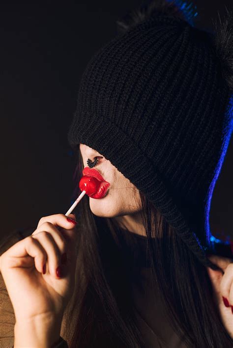 Sexy Girl With Lollipop In Her Mouth Takes A Cold Ride With Black Background And Colorful