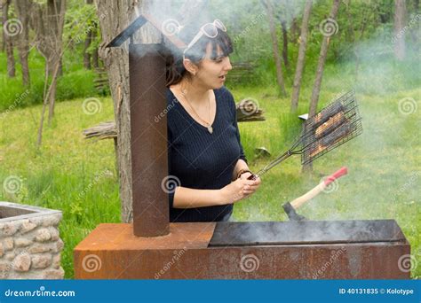 Attractive Woman Cooking Meat Over A Barbecue Stock Image Image Of