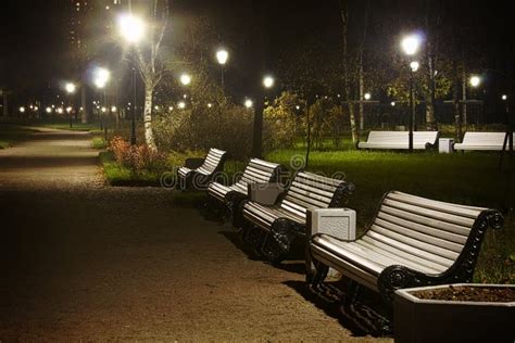 White Benches In The Park Night Time With Vignette And Glow Stock