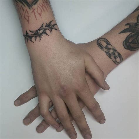 Red heart rosary cross tattoo. Thorn and chain wrist tattoos.