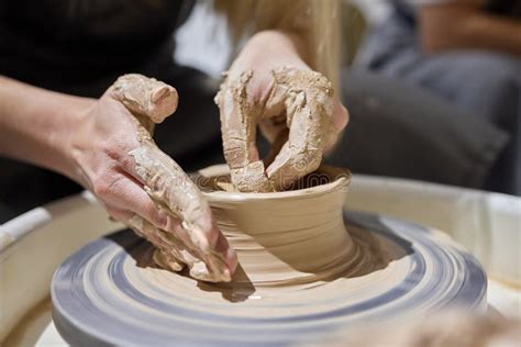 Close Up Shot Of Hands Of Crafts People Working With Clay In Pottery