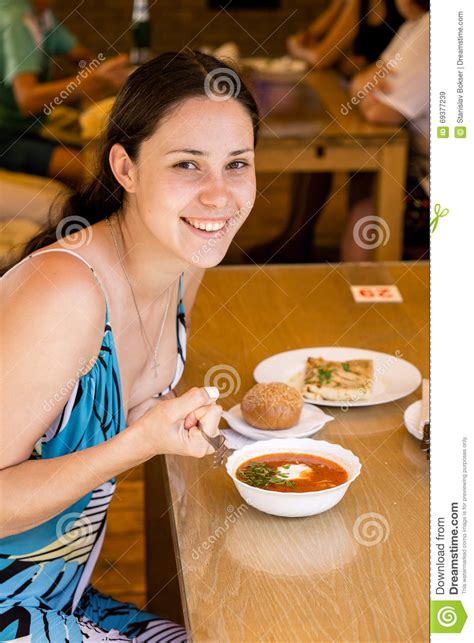 Smiling Girl In Blue Dress Sitting At Table Stock Image Image Of