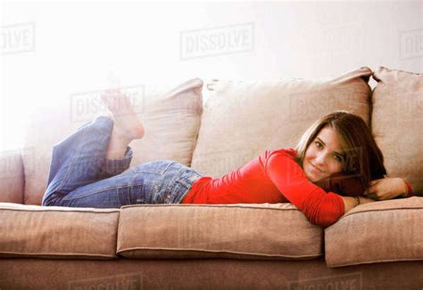 Caucasian Woman Laying On Sofa Stock Photo Dissolve