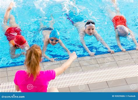 Happy Children Kids Group At Swimming Pool Class Learning To Swim Stock