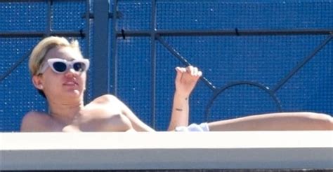 Miley Cyrus Caught Sunbathing Topless On A Rooftop