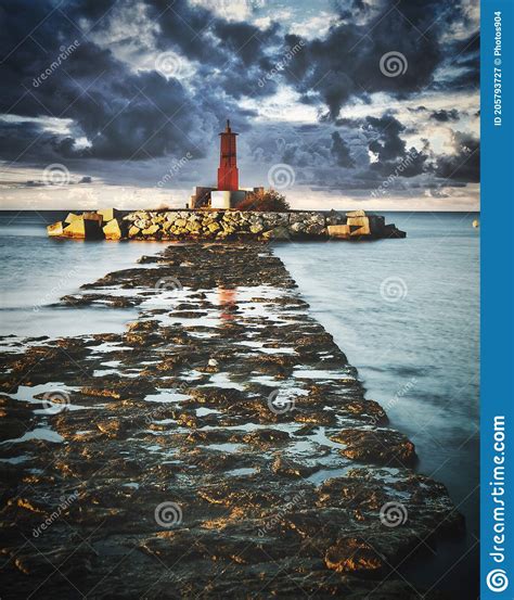 Lighthouse In A Cloudy Sunrise In Long Exposure Stock Image Image Of