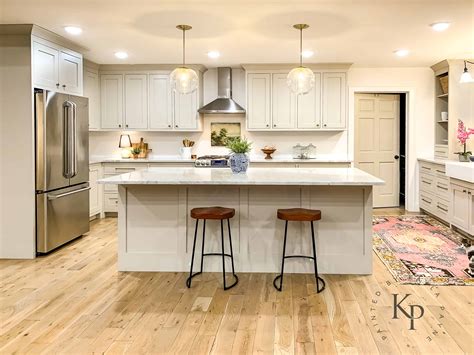 Using white is often one of the best choices as the color easily blends in to whatever finishes and colors your use in other rooms of the house. Revere Pewter Kitchen Cabinets - Painted by Kayla Payne