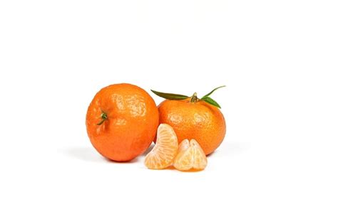 Premium Photo Two Orange Mandarin And Three Peeled Mandarin Slices