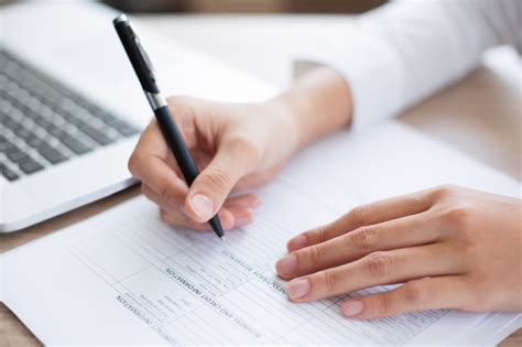 Free Photo Closeup Of Business Person Completing Form