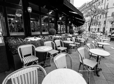 Outdoors Street Cafe With Round Tables And Wicker Chairs Stock Image