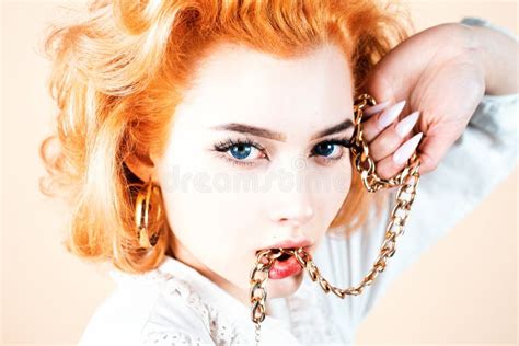 Redhead Woman Close Up Portrait With Golden Chain In Mouth Stock Image