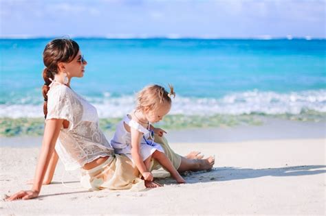 Premium Photo Beautiful Mother And Daughter On The Beach Enjoying Summer Vacation