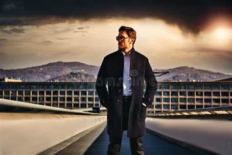 One Handsome Elegant Young Man In Urban Setting With Coat Stock Photo