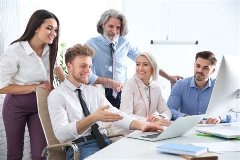 Business People Discussing Work Matters At Table In Office Stock Image
