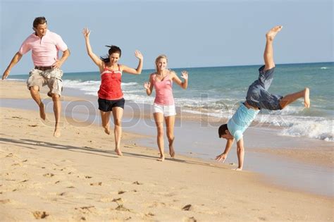 Group Of Friends Enjoying Beach Holiday Stock Image Colourbox