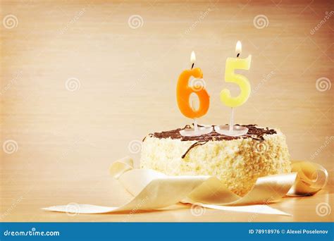 Birthday Cake With Burning Candle As A Number Sixty Five Stock Photo