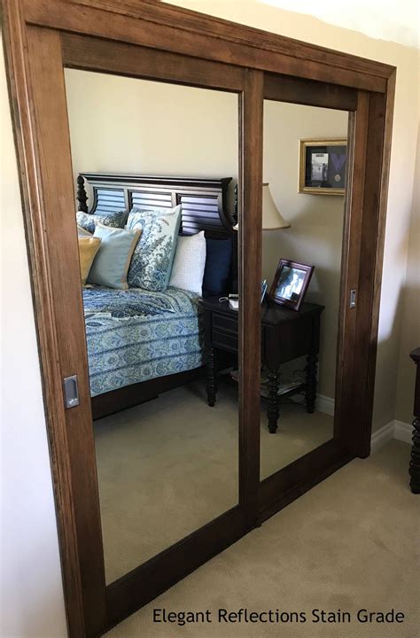 An Image Of A Bedroom With Mirrored Closet Doors