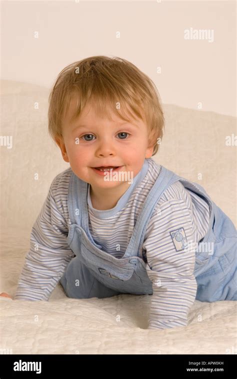 One Year Old Baby Boy On Bed Smiling Stock Photo Alamy