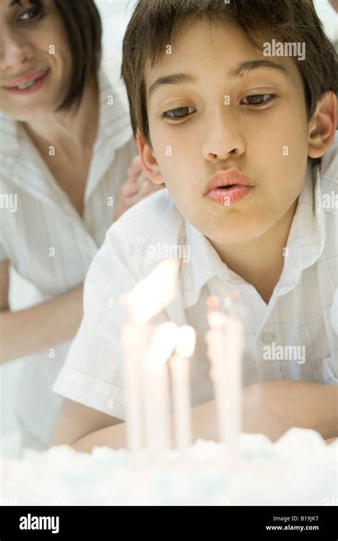 Boy Blowing Out Candles On Birthday Cake Close Up Stock Photo Alamy