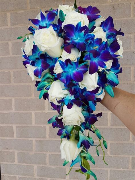 Modern bouquets & unique plants designed to impress. A wired tear drop bouquet of white roses with blue ...