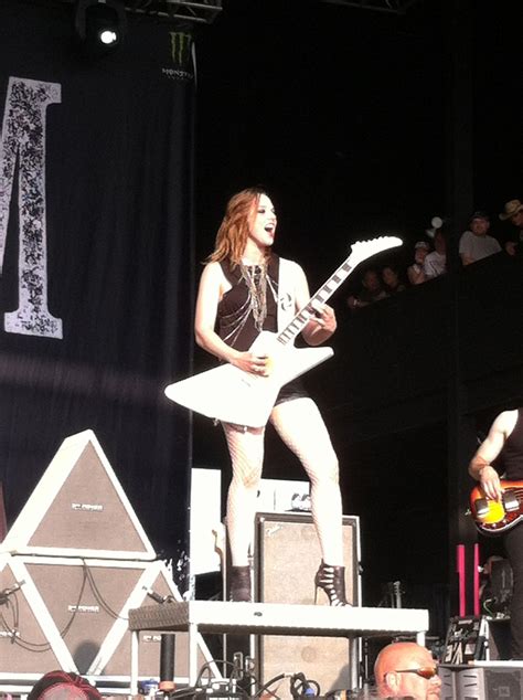 A Woman With An Electric Guitar On Stage