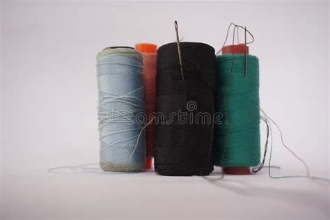 Several Piles Of Sewing Thread Spools Of Various Colors Isolated On A