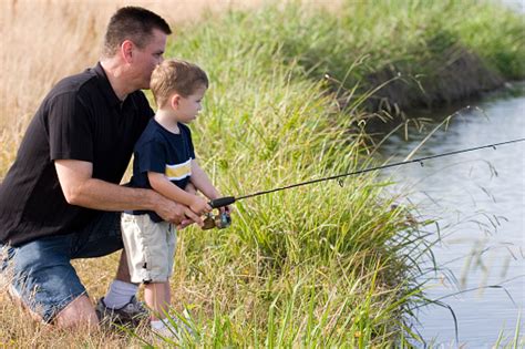 Dad Helping Son Fish Stock Photo Download Image Now Istock